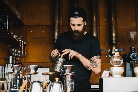 male barista pouring coffee